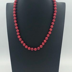 Red faux pearl necklace and bracelet.